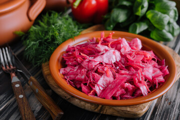Salad with cabbage and beetroot on wooden table