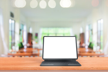 Digital tablet mock up placed on wooden table in blurred coffee shop or restaurant for menu or order receipt from computer for mockup design