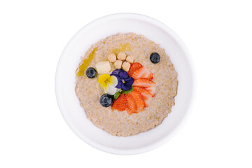 Oatmeal porridge with blueberries, strawberries and hazelnuts