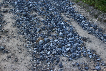 Country road filled with slag from metallurgical production