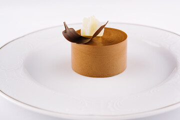 Plate with coffee panna cotta on white