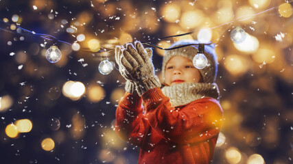 little girl with christmas lights enjoying the holidays