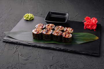 Traditional fresh japanese sushi futomaki on black stone