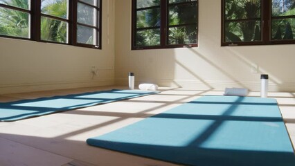 Panning on yoga mats in well lit tropical work out room at beach resort in slow motion