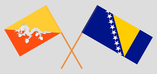 Crossed flags of Bhutan and Bosnia and Herzegovina. Official colors. Correct proportion