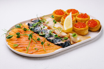 Assorted fish on a plate. smoked and salted fish