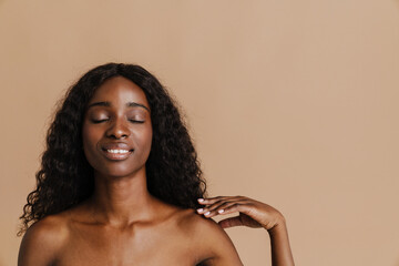 Young beautiful smiling curly naked african woman with closed eyes