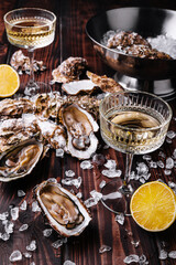 Fresh oyster and wine glass with ice cubes