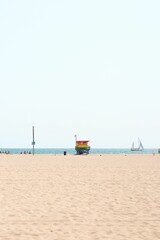 Fototapeta premium Vertical shot of a rainbow lifeguard post on Venice beach, California