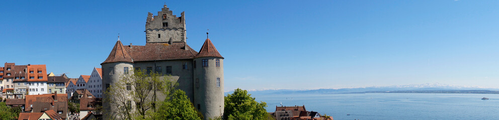 Northwest side of the beautiful and romantic Meersburg castle or Burg Meersburg, Lake Constance (Bodensee) is in the background at sunset (Germany)	