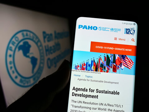 Stuttgart, Germany - 09-10-2022: Person Holding Cellphone With Webpage Of Pan American Health Organization (PAHO) On Screen In Front Of Logo. Focus On Center Of Phone Display.