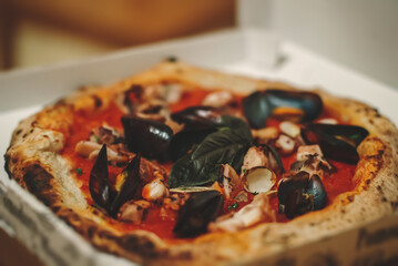 Pizza with mussels, squid and clams. Frutti di mare.