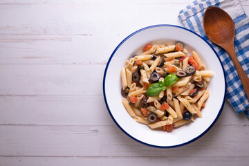 Sicilian pasta with olives, tomato and olive oil. Traditional recipe from the island of Sicily.