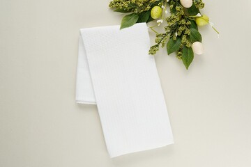 White waffle kitchen towel mockup for Easter design presentation, blank cotton tea towel and Easter decorations on table.