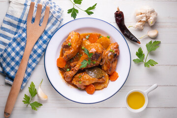 Chicken with vegetable sauce, carrots, peas and potato. Traditional Spanish dish recipe.