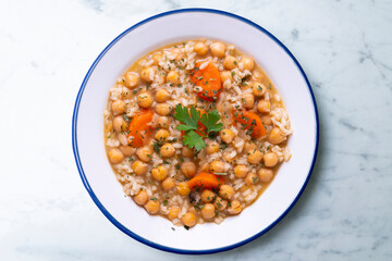 Fototapeta na wymiar Chickpea stew with rice and carrots. Typical Spanish gastronomy dish.
