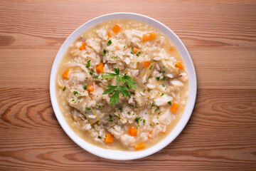 Soupy rice with artichokes and carrots. Typical Spanish gastronomy platter.