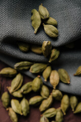 Green aromatic cardamom on fabric close up