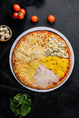different types of cheese on a big pizza