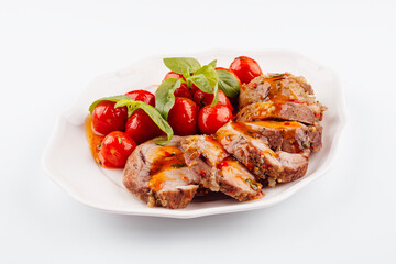 Baked meatloaf with spinach and tomatoes isolated on white