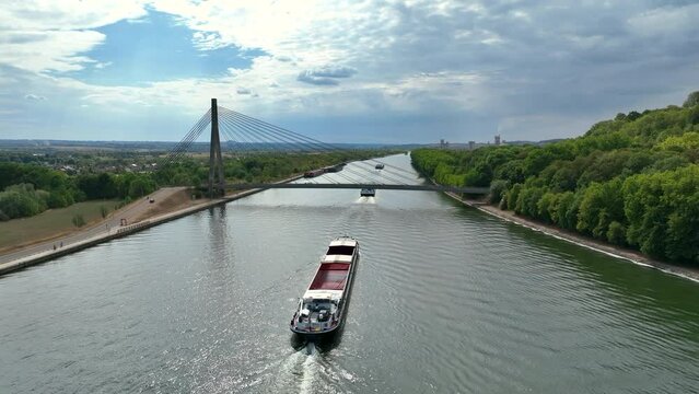 Freight ships sailing on the Albert Canal towards Li&egrave;ge close to the river Meuse and the Lanaye locks. Drone point of view.