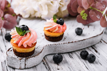 Chocolate cupcakes with pink cream and fresh blueberry
