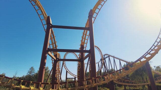 following roller coaster cart making 3 loopings in theme parc asterix sunny day