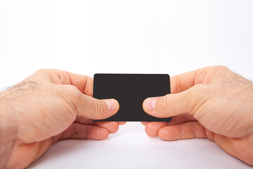 The man is holding a credit card in his hand.