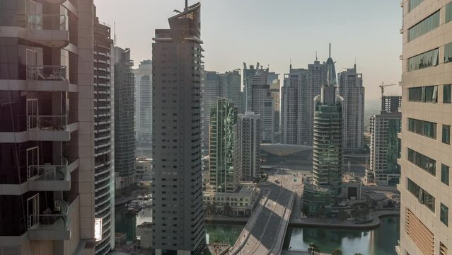 Aerial view on Dubai Marina skyscrapers and the most luxury yacht in harbor morning timelapse, Dubai, United Arab Emirates