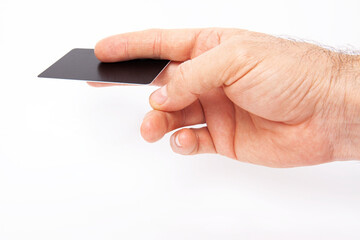 The man is holding a credit card in his hand.