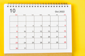 The October 2022 Monthly desk calendar for 2022 year on yellow background.