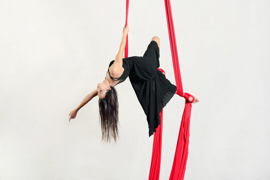 Female aerialist performing trick on aerial silks