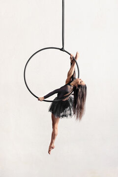 Woman performing split on aerial hoop