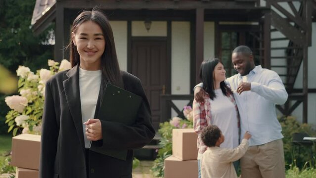 Portrait of a successful Asian female real estate agent who made a successful deal.Multiracial Family,Mixed Race,Diverse People,Multiethnic Relations