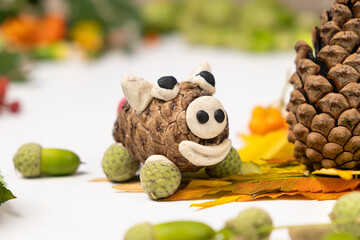 Pig figurine made of cone and plasticine, children's crafts.