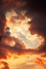 Fluffy clouds against evening sky at sunset