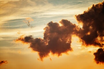 Fluffy clouds against evening sky at sunset