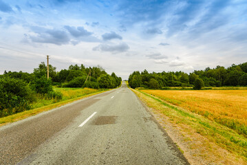 A country empty road along with nature,holiday and travel concept.Summer day.