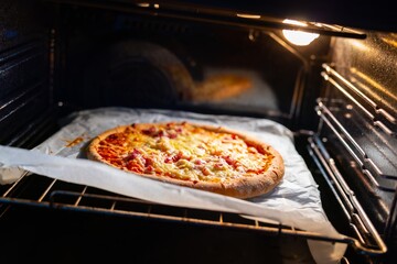 Home made pizza in the oven ready to be taken out