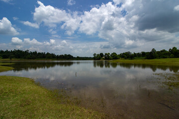 The beautiful Ketki Lake at Belpahari, Jhargram with reflection of blue sky and white clouds. Selective focus.