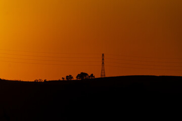 sunset on the horizon towers and plane 