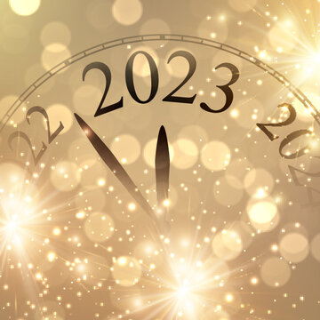 New year clock showing 2023 with golden firework and bokeh lights.