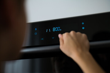 Detail of a child's hand while using a microwave. touch display microwave oven