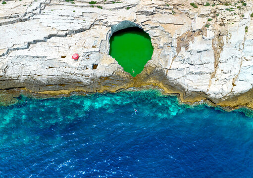 Aerial view of tourists bathing in the Giola, a natural pool on Thassos island, Greek Islands, Greece