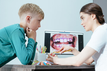 Young boy at the dentist learning dental hygiene