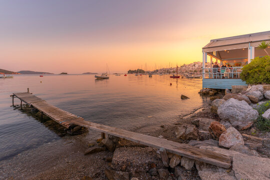 View of boats and restaurants in Skiathos Town at sunset, Skiathos Island, Sporades Islands, Greek Islands, Greece