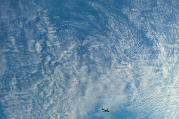 blue sky with clouds an plane