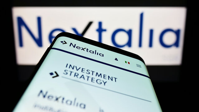 Stuttgart, Germany - 09-10-2022: Smartphone with webpage of Italian investment company Nextalia SGR SpA on screen in front of business logo. Focus on top-left of phone display.