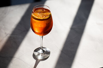 photography of aperol spritz cocktail glass with orange slice photo taken with light and shadow