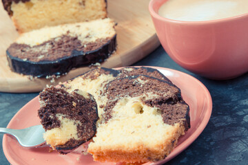 Fresh baked yeast cake with cocoa, cup of cappuccino. Delicious dessert